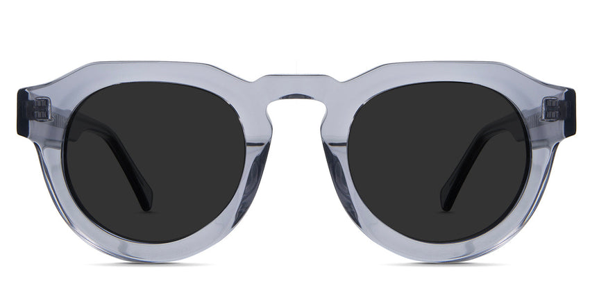 Jax  Gray Polarized in periwinkle variant - is a narrow transparent frame with high keyhole shaped nose bridge and the crystal temple arms has visible silver wire core 