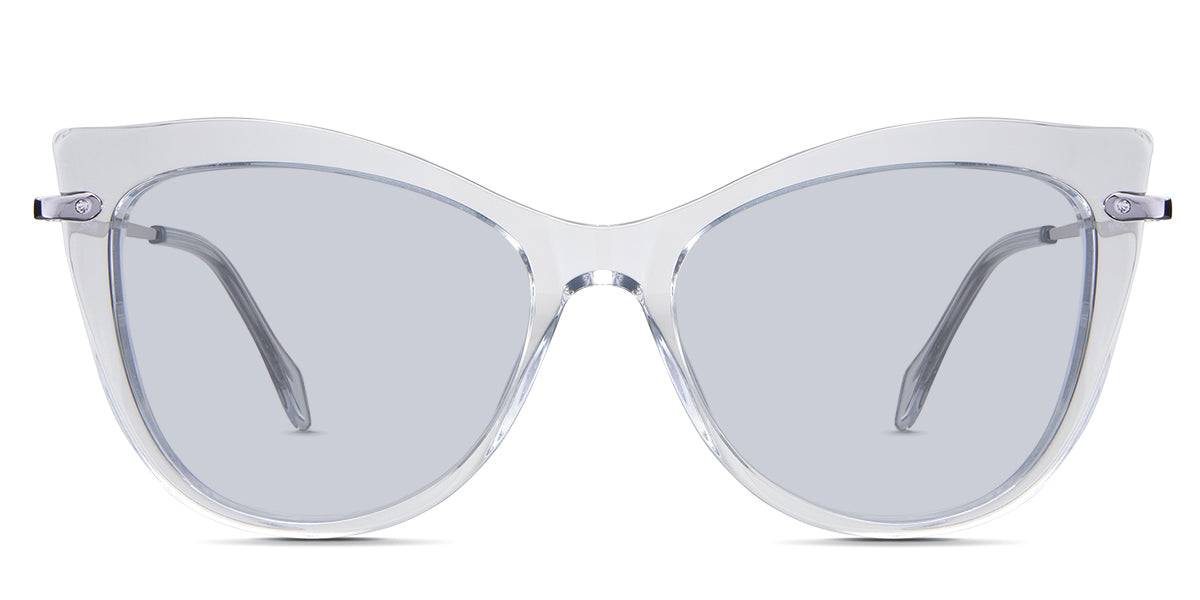 Susan Blue Tinted Solid in the Crystal variant - is a cat-eye frame with a U-shaped nose bridge and a combination of metal arm and acetate tips.