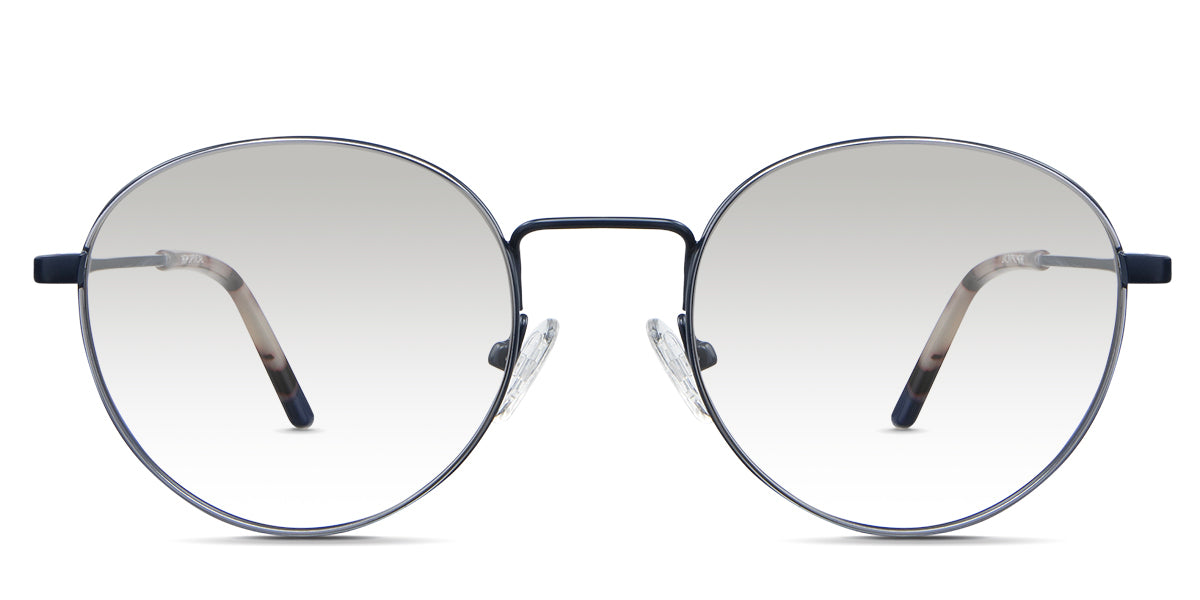 Adler Black Tinted Gradient in the Capri variant - it's a round frame with a high nose bridge and a slim metal arm and acetate tips.