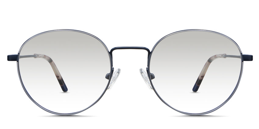 Adler Black Tinted Gradient in the Capri variant - it's a round frame with a high nose bridge and a slim metal arm and acetate tips.