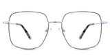 Carmela eyeglasses in the chinchilla variant - its a slightly tall metal frame in black and silver color.