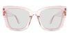 Chet black tinted Standard Solid sunglasses in the flamingo variant are a transparent frame with the company logo outside the temple arm on both sides.