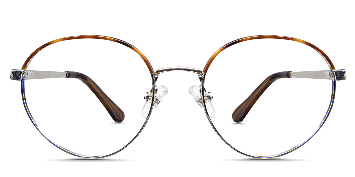 Coyle eyeglasses in the earthen variant - the front rim of it has a half-tortoise brown and golden color, while the other half is silver.