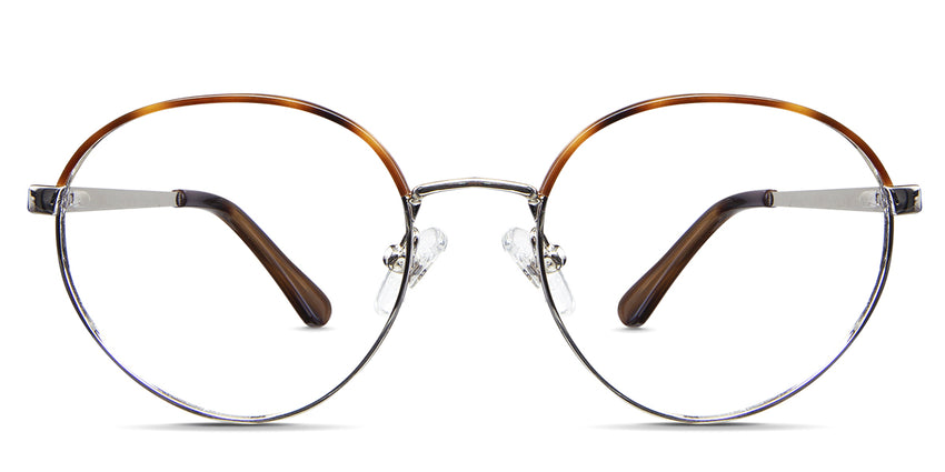 Coyle eyeglasses in the earthen variant - the front rim of it has a half-tortoise brown and golden color, while the other half is silver. Metal New Releases Latest Bold