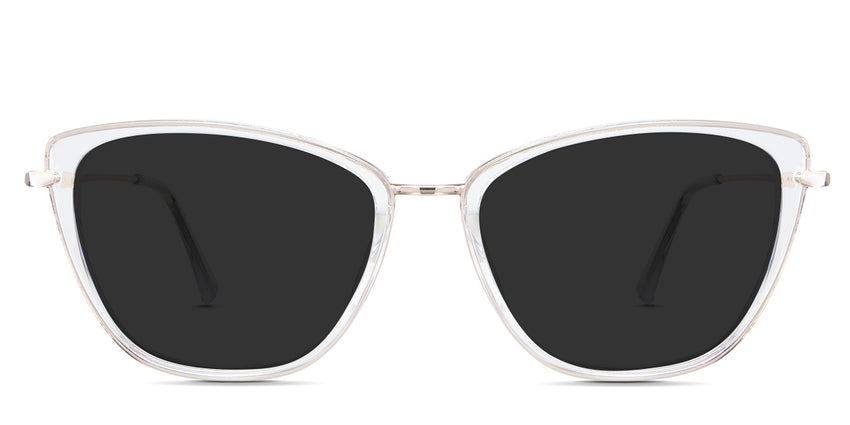 Ira black tinted Standard Solid sunglasses in the Selenite - it's a crystal clear cat-eye shape frame. An acetate frame with a gold metal rim.