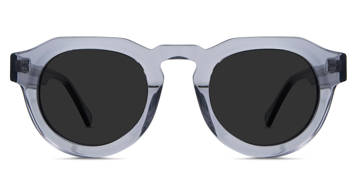 Jax  black tinted Standard Solid sunglasses in periwinkle variant - is a narrow transparent frame with high keyhole shaped nose bridge and the crystal temple arms has visible silver wire core 