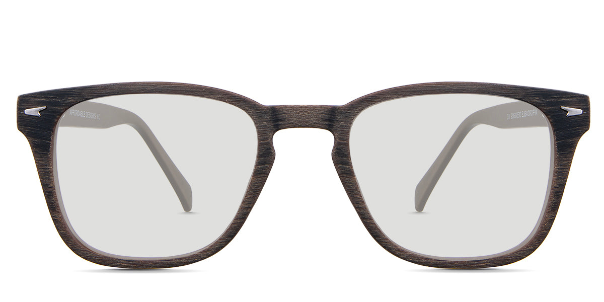 Senecio black tinted Standard Solid glasses in the elmwood variant - it's a square full-rimmed frame with a wooden pattern and a metal emboss in the end piece.