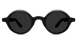 Naxo black tinted Standard Solid sunglasses in the midnight variant - it's a round frame with a U-shape nose bridge.