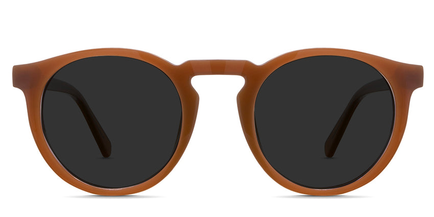 Rino black tinted Standard Solid sunglasses in the saffron variant - is a full-rimmed round shape frame with a keyhole nose bridge and a visible wire core.