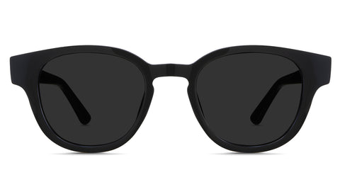 Aris black tinted Standard Solid sunglasses in the midnight variant - it's an oval acetate frame with a keyhole shape nose bridge and a long temple arm with a hockey shape tip.